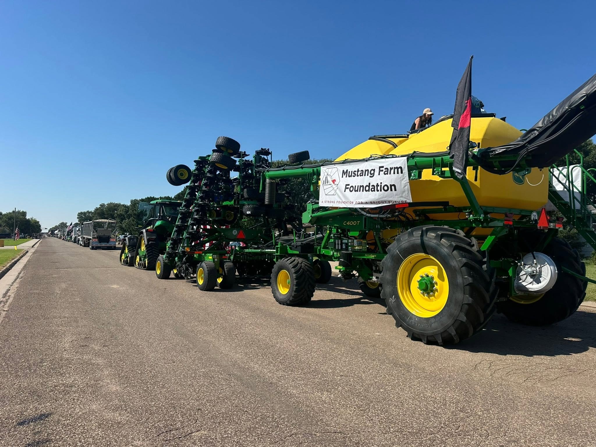 Mustang Farm Foundation equipment lineup in a parade