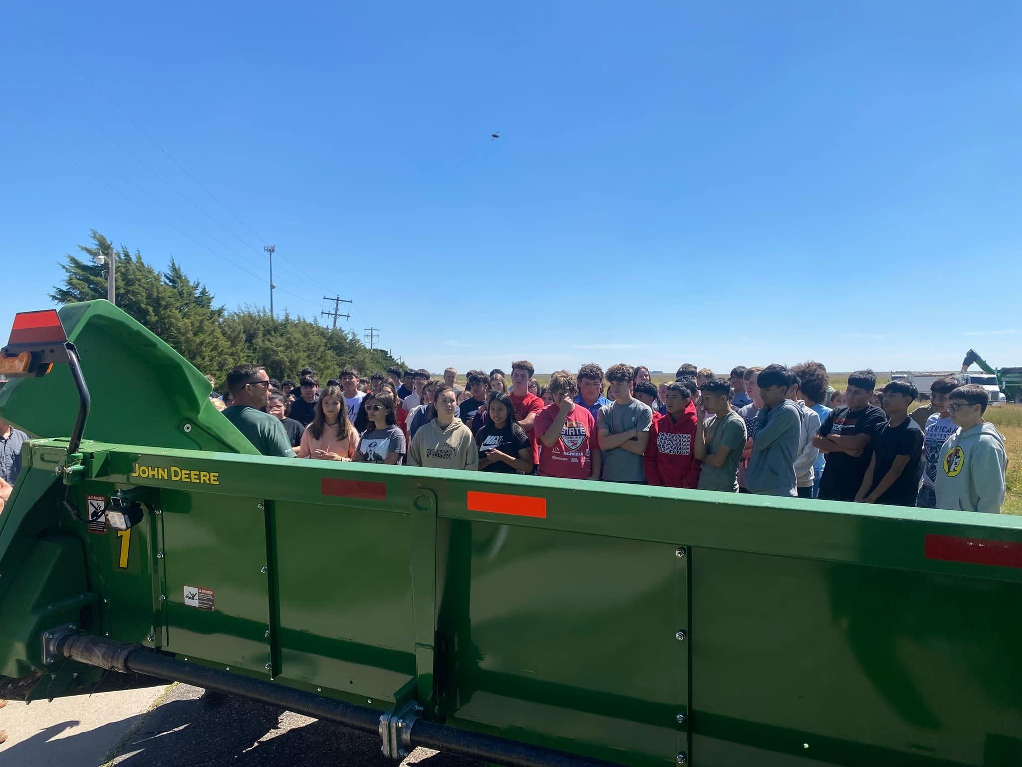 Students learning about John Deere farm equipment at a foundation event