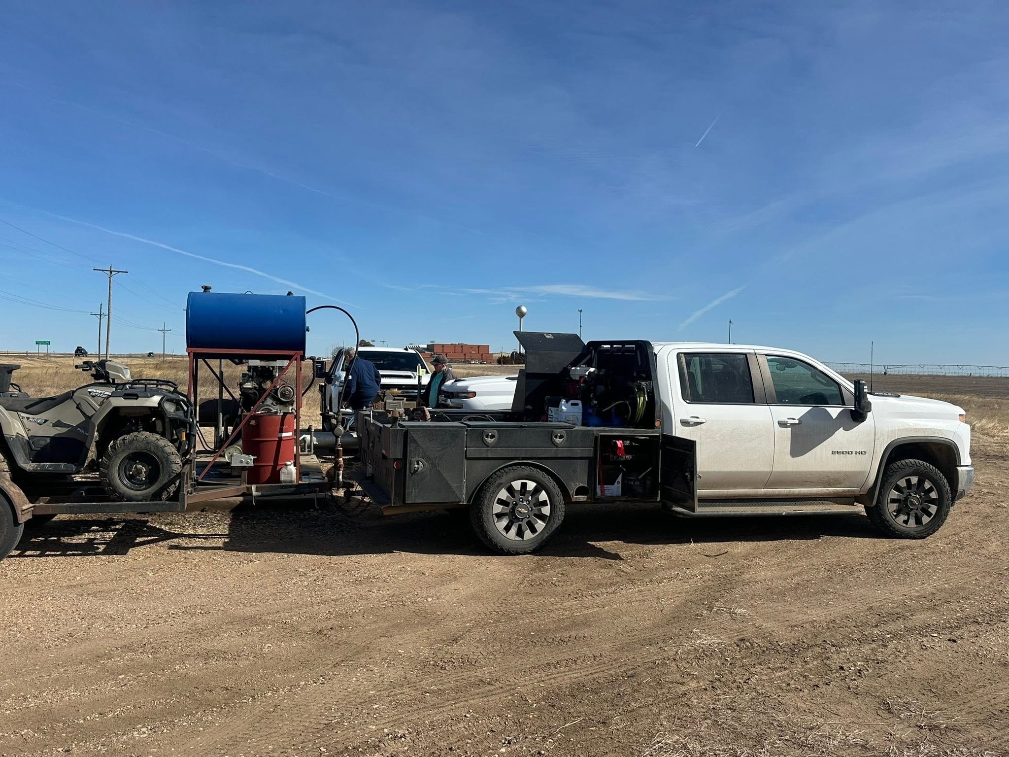 Pickup truck with equipment at a rural work site